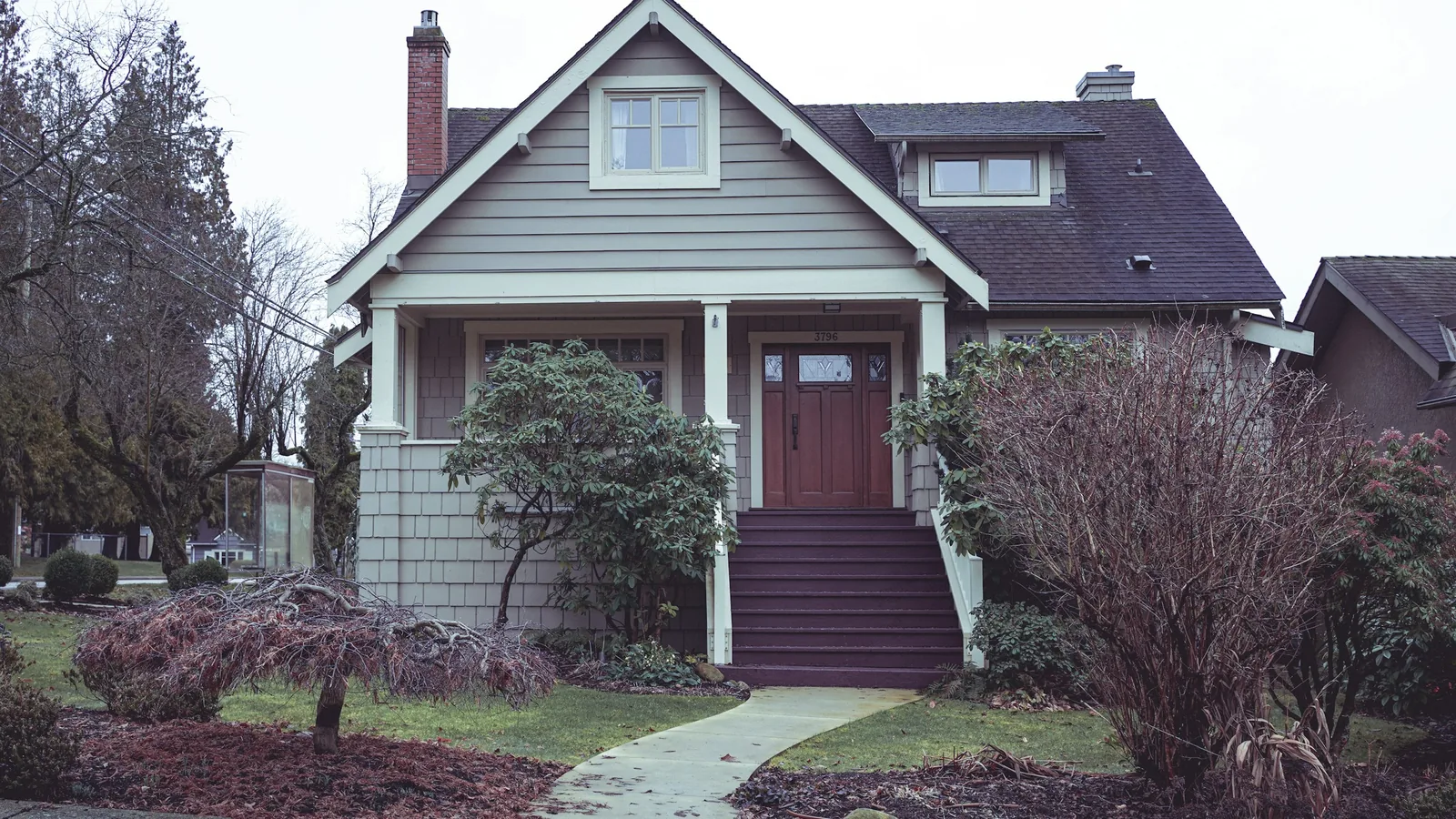A house with a red door and steps leading to it, Vancouver