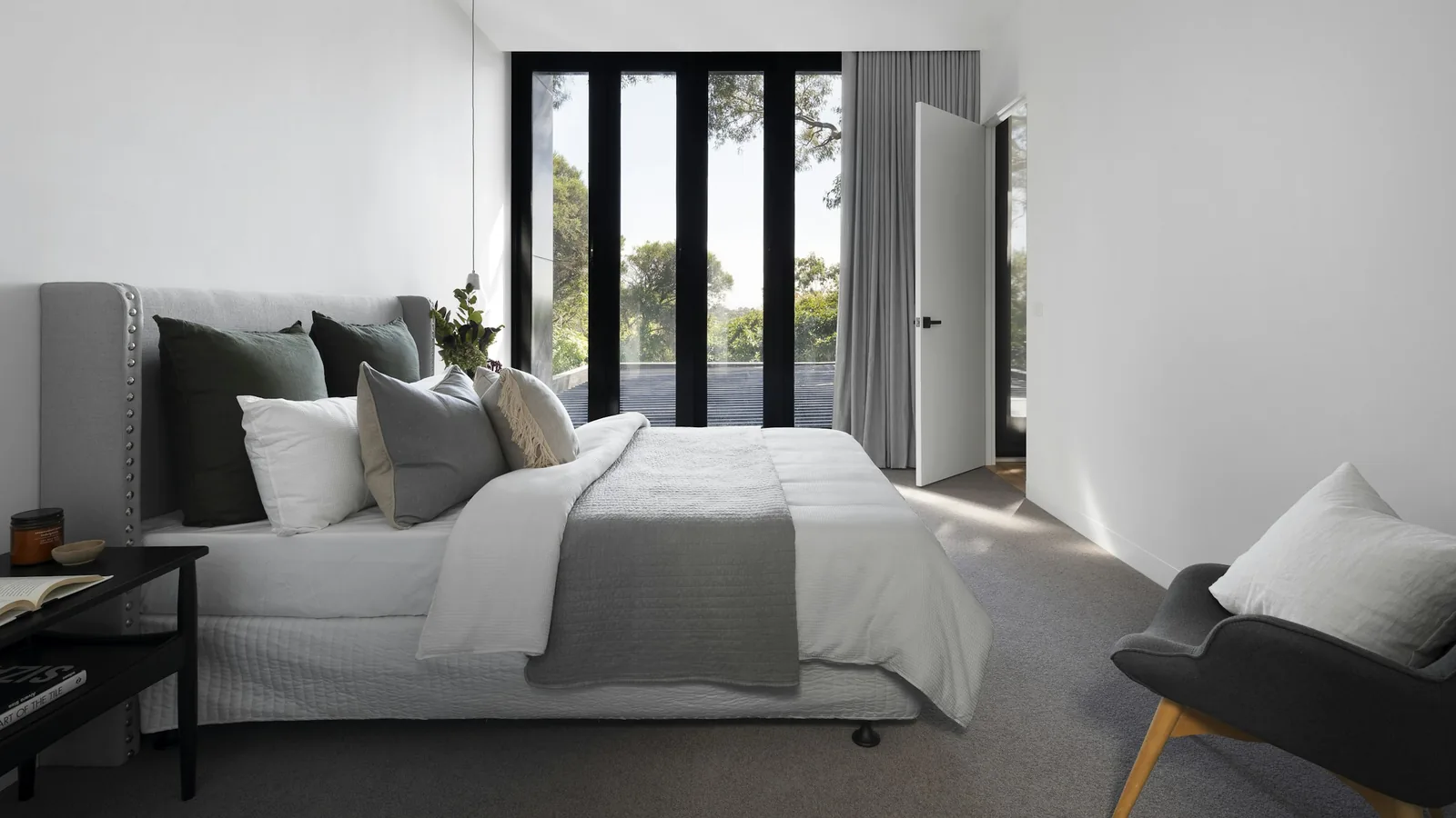 Bright, simply furnished bedroom with a garden view