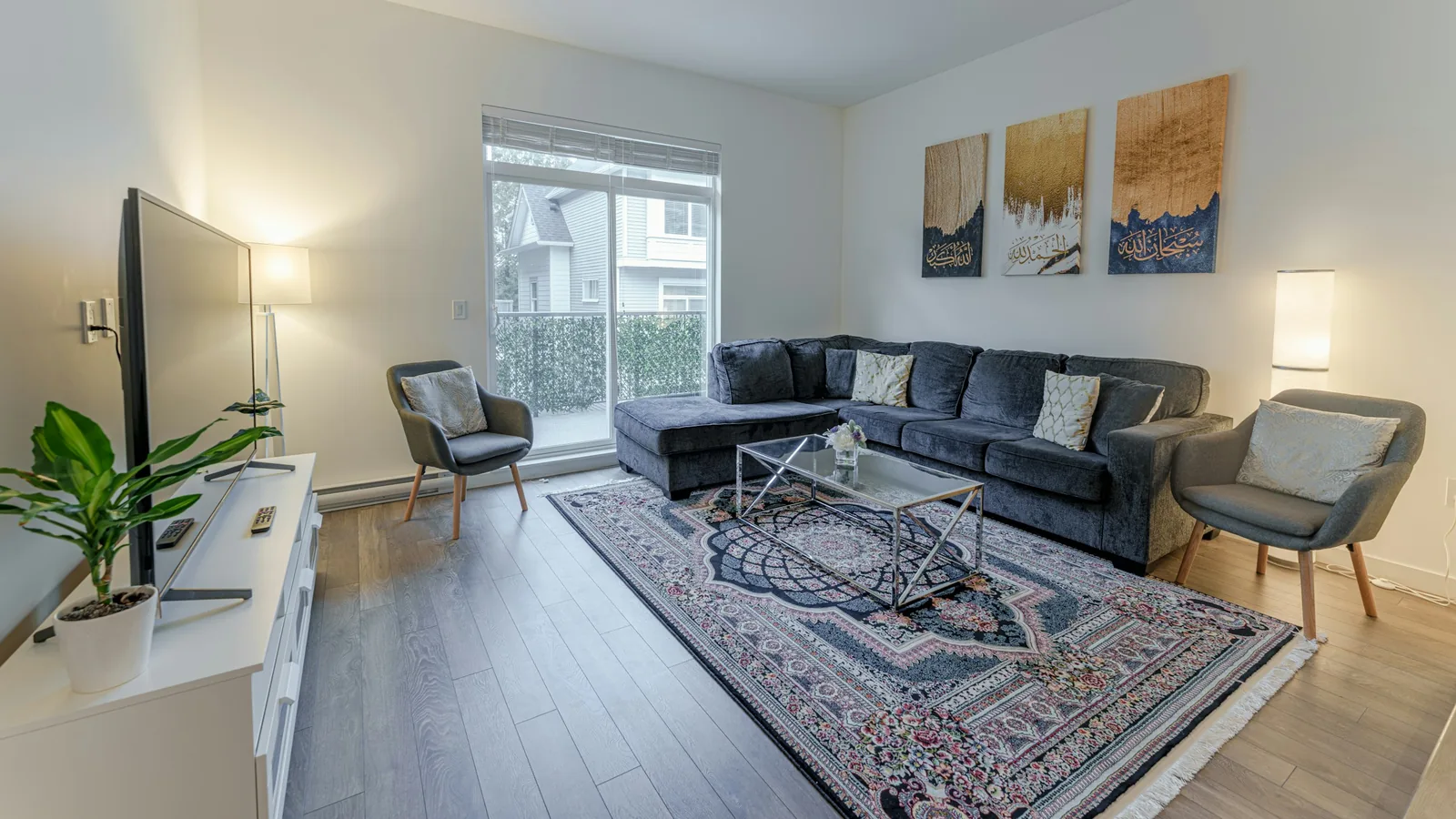 A living room filled with furniture and a large rug, condo towers