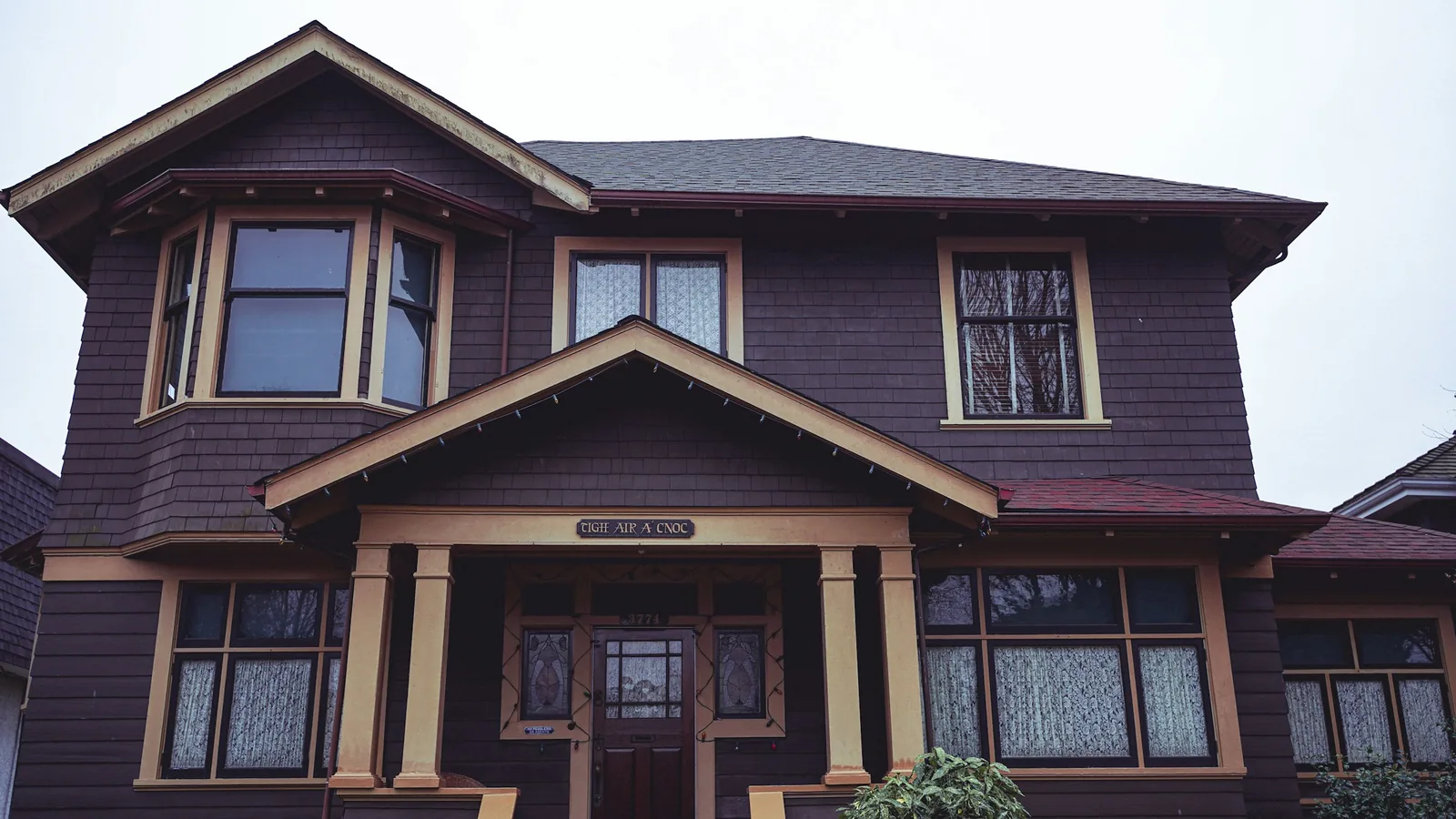 A large brown house with a clock on the front of it, Vancouver