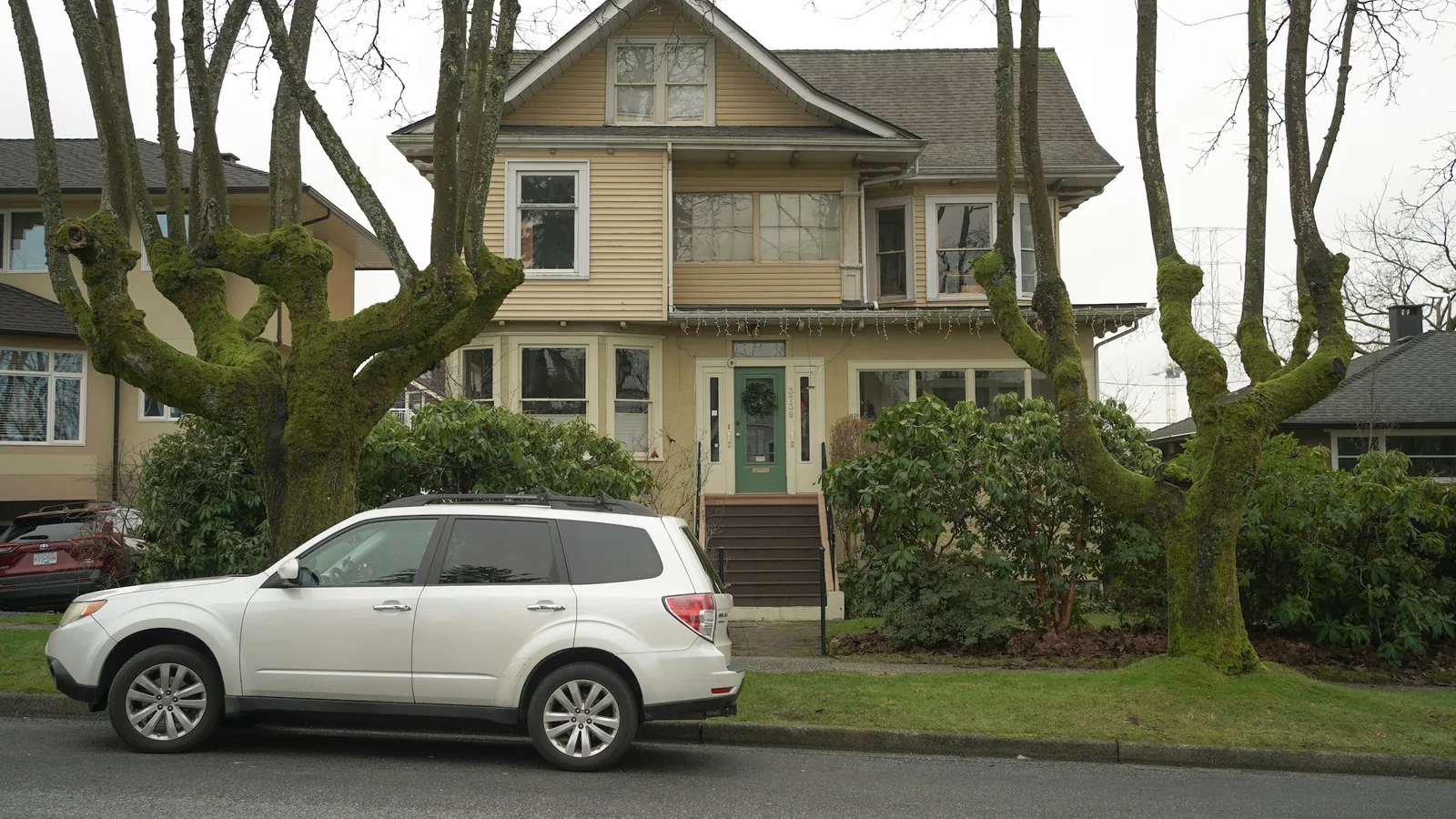 A white car parked in front of a house, Vancouver