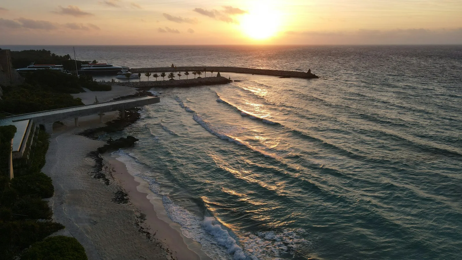 Aerial view of a sandy beach at sunset