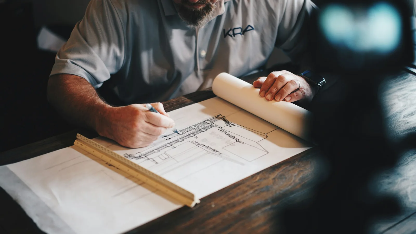 Architect reviewing house plans at a drafting table