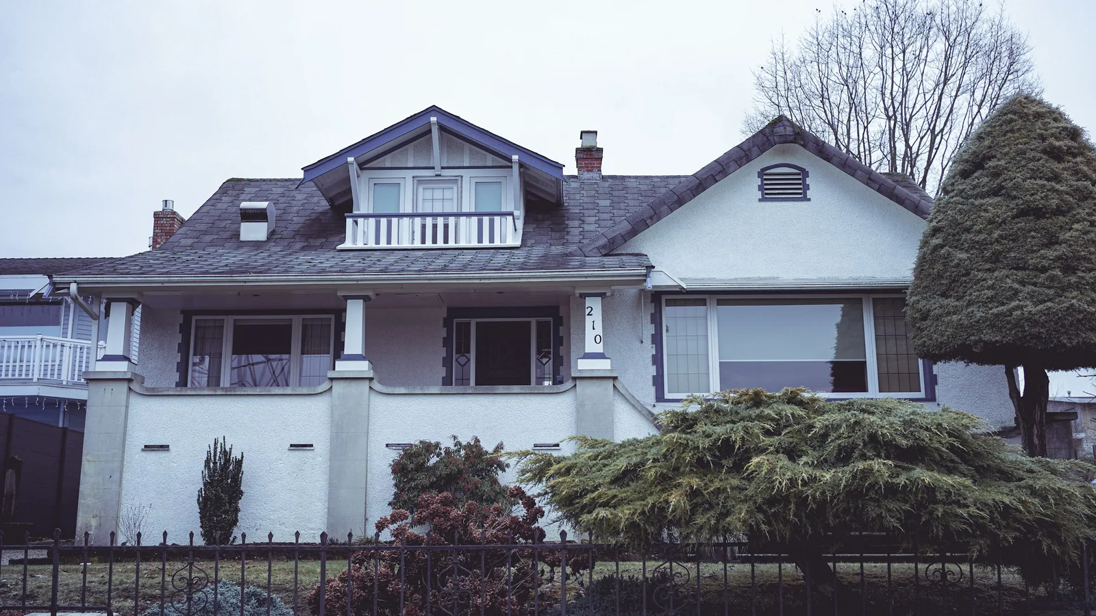 A white house with a black fence in front of it, Vancouver