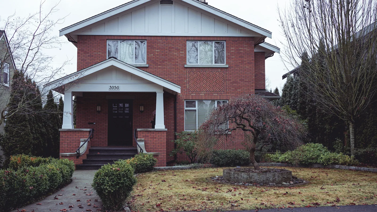 A red brick house with white trim and a black door, Vancouver