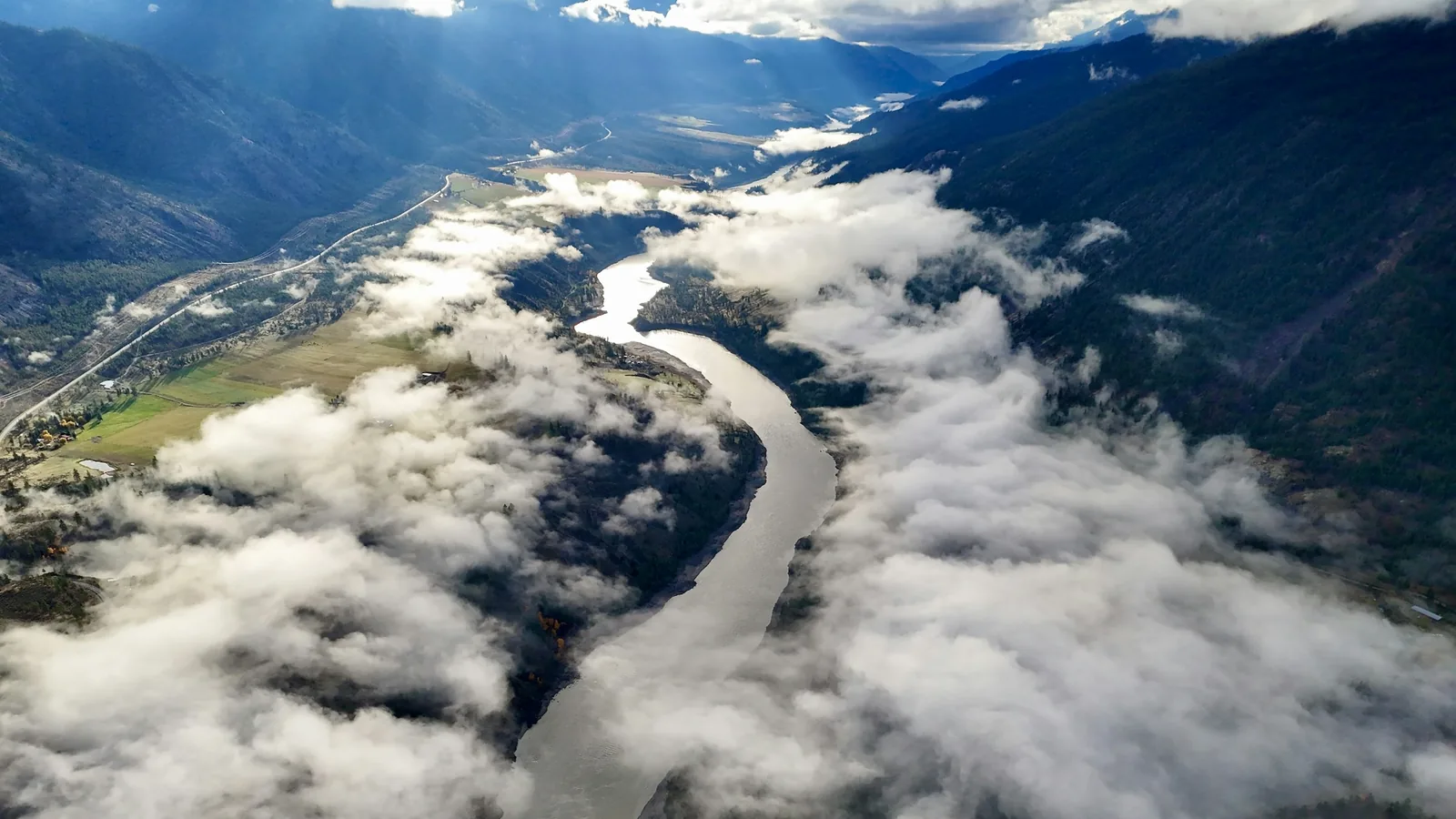 An aerial view of a river running through a valley, the Fraser Valley