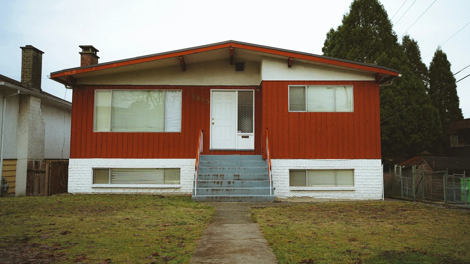 A red and white house with steps leading to the front door, Vancouver