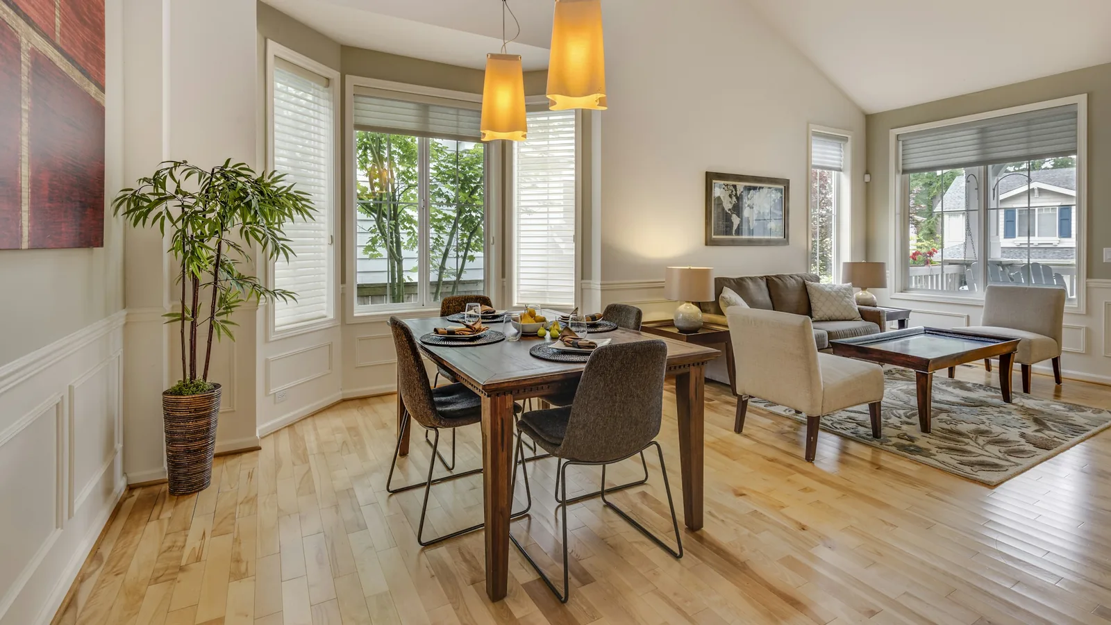 Sunlit dining room with bay windows and hardwood floors