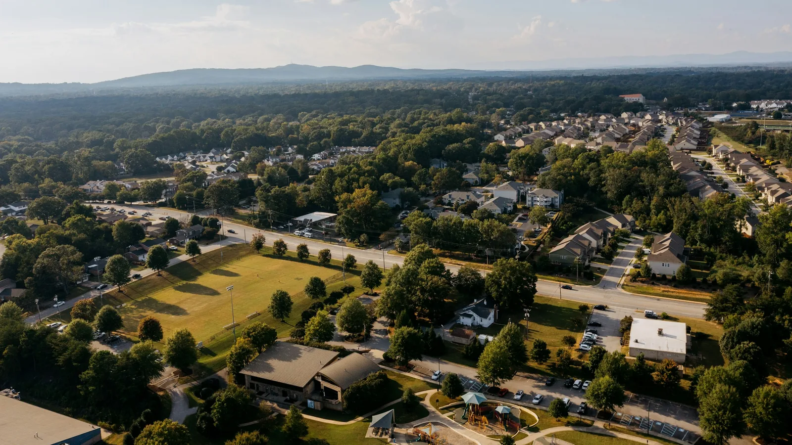Aerial view of a planned suburban neighbourhood with parks and playing fields