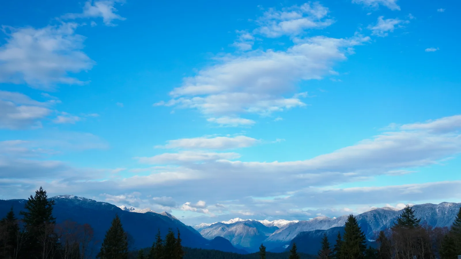 Snow-capped Coast Mountains under a blue sky