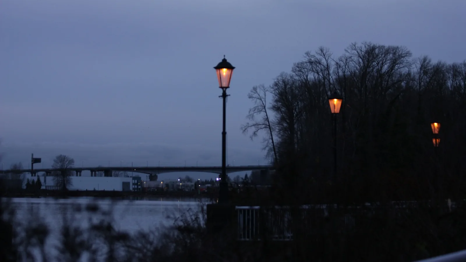 Lamp posts at dusk with the Lions Gate Bridge in the distance