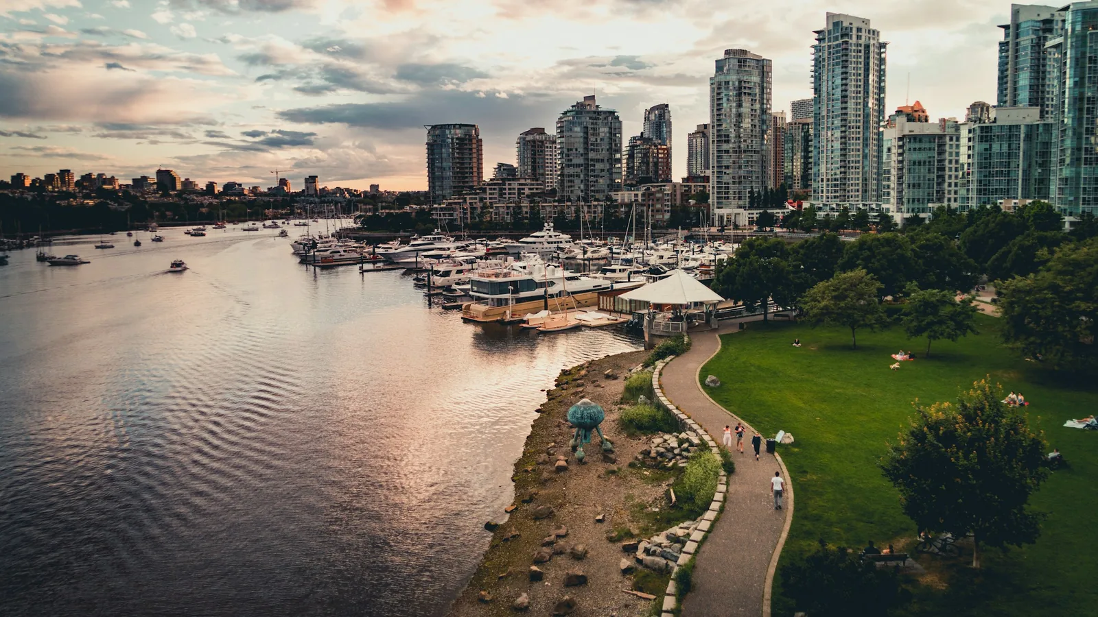 White boat on river near city buildings during daytime in Vancouver