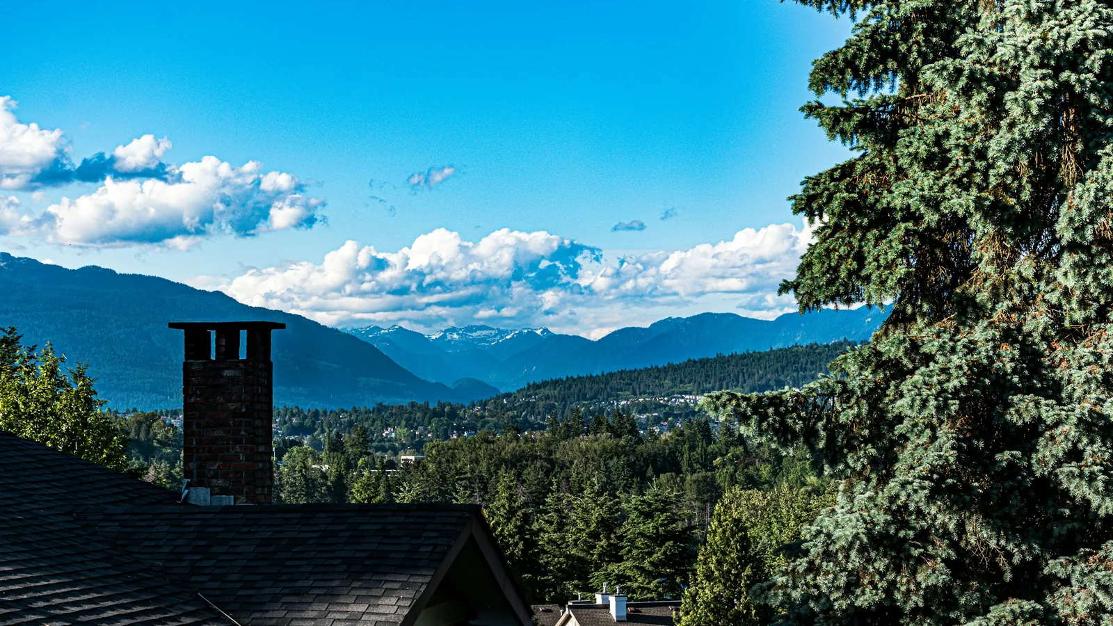 View over rooftops to the North Shore mountains