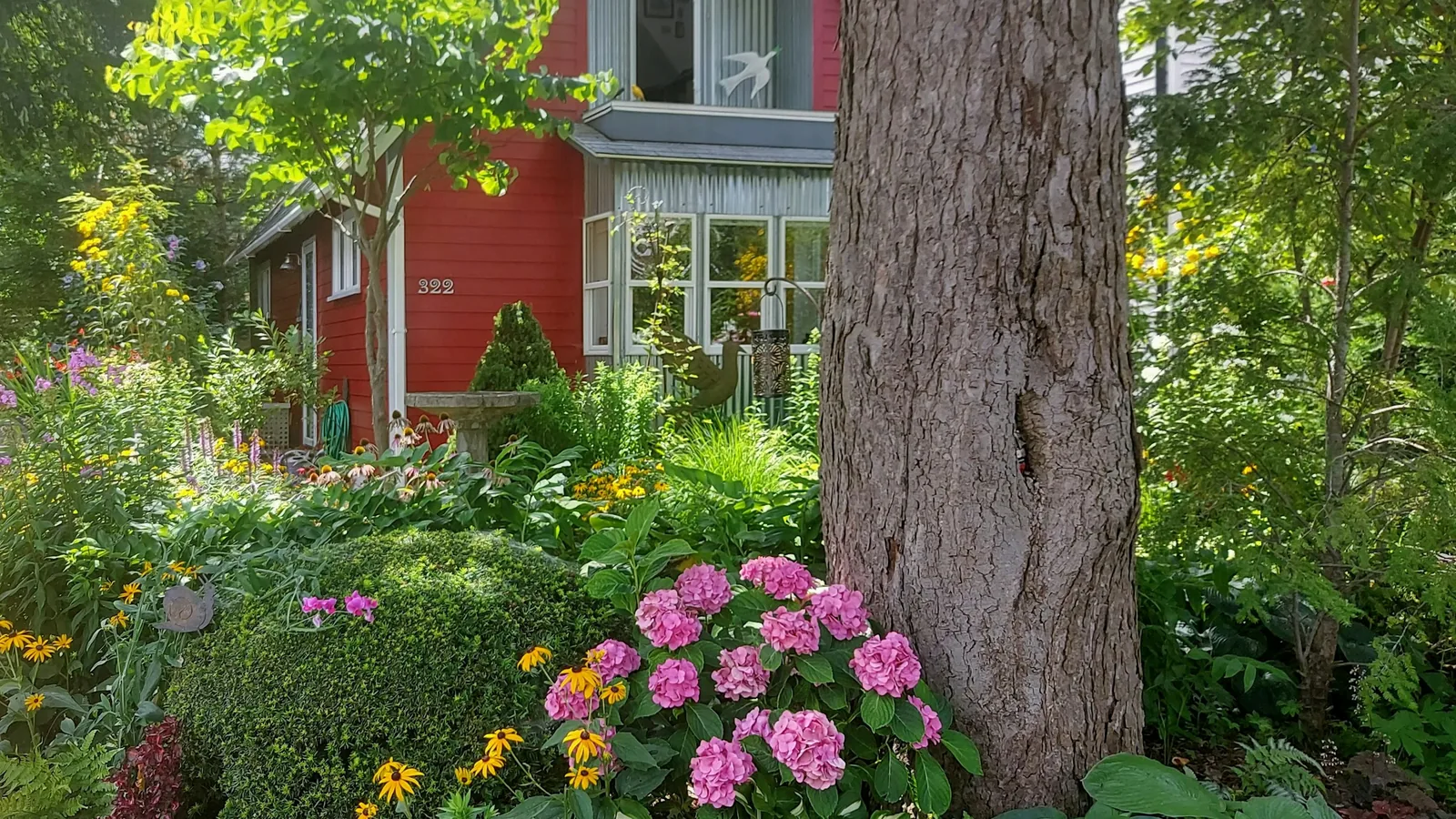 Red-sided home with a flowering front garden