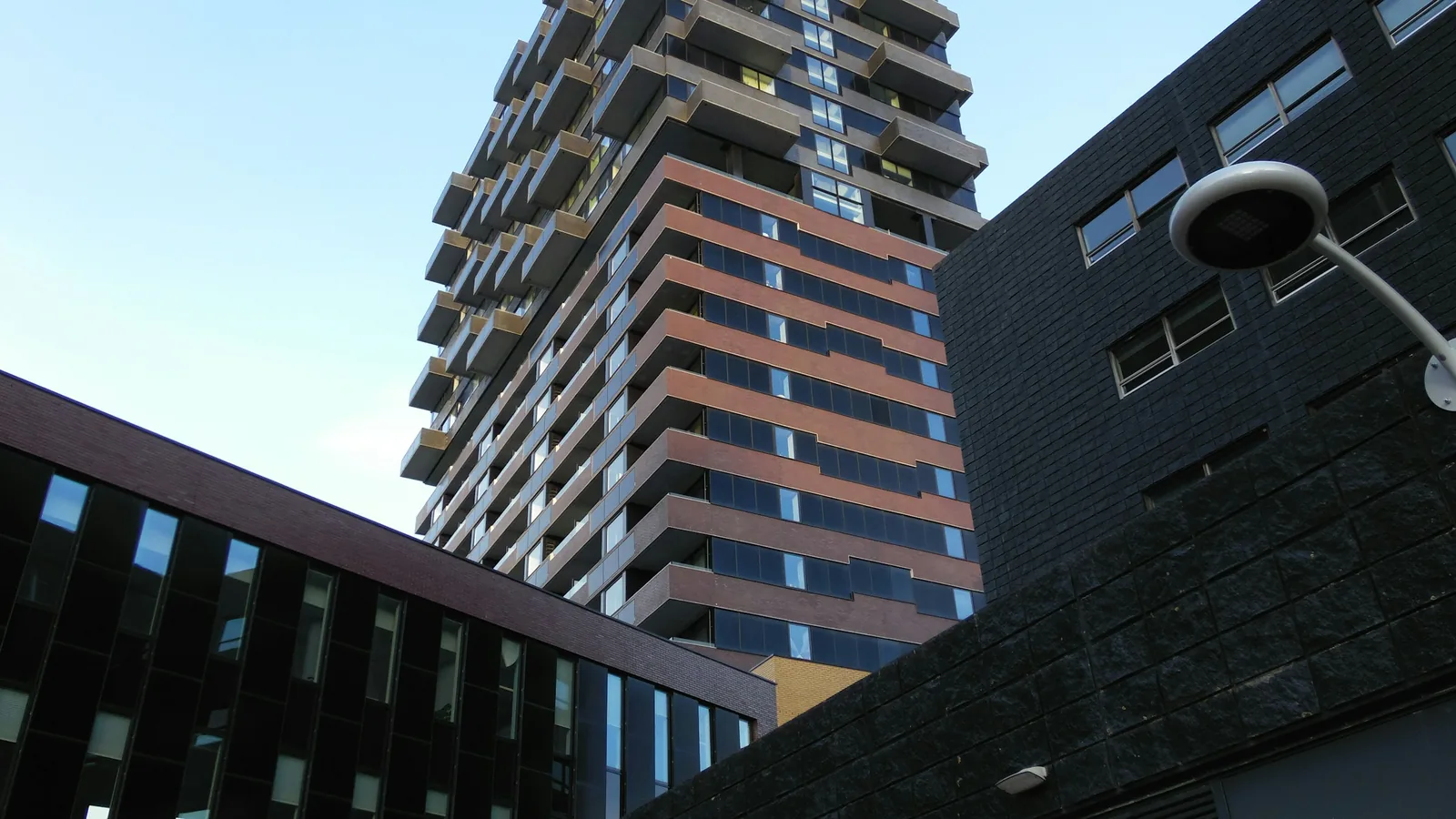 New concrete condo tower against a bright sky