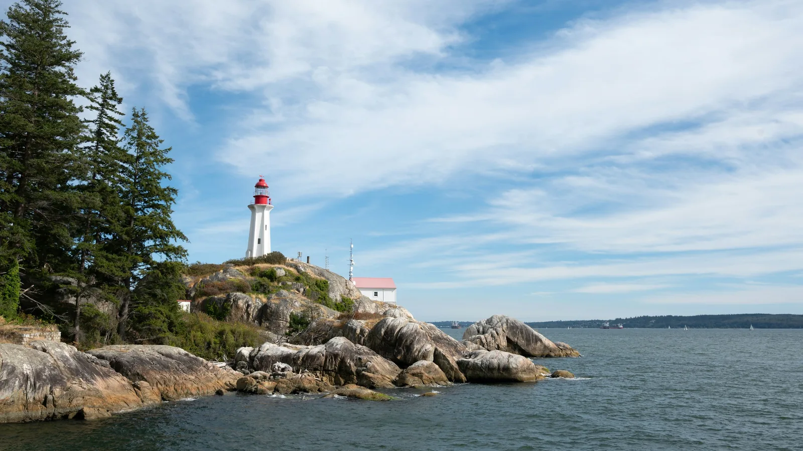 A light house sitting on top of a rocky shore, Vancouver's North Shore