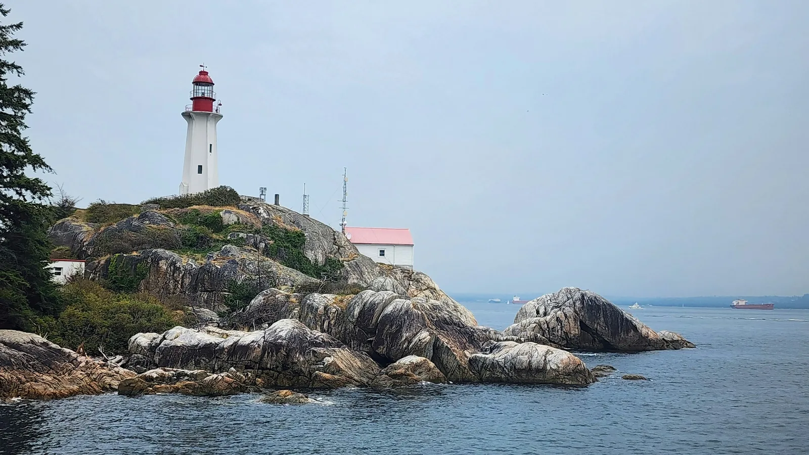 A light house on a rocky outcropping in the ocean, Vancouver's North Shore